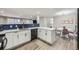 Updated kitchen featuring a breakfast bar, modern appliances, and a clean, open layout at 8340 W 70Th Ave, Arvada, CO 80004