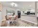 Eat-in kitchen featuring an adjacent dining area, stainless appliances, and modern lighting at 8340 W 70Th Ave, Arvada, CO 80004