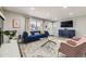 Bright living room with modern decor, hardwood floors, and large windows at 8340 W 70Th Ave, Arvada, CO 80004