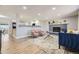 Open-concept living room featuring a cozy fireplace, hardwood floors, and stylish furnishings at 8340 W 70Th Ave, Arvada, CO 80004
