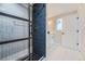 The modern walk-in shower features a sleek design with black framing, complemented by elegant tile work at 8340 W 70Th Ave, Arvada, CO 80004