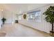 Sunroom with whitewashed walls, wood laminate flooring, and lots of natural light at 8340 W 70Th Ave, Arvada, CO 80004