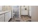Open concept bathroom with double vanities and modern fixtures, and tile flooring at 27130 E Maple Ave, Aurora, CO 80018