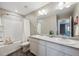 Bright bathroom featuring a double vanity with modern fixtures and a tub/shower with white tiling at 27130 E Maple Ave, Aurora, CO 80018