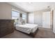 Bedroom with large windows, carpeted floors, and a light gray color palette at 27130 E Maple Ave, Aurora, CO 80018