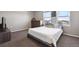 Bright bedroom with carpeted floors, and large windows overlooking the neighborhood at 27130 E Maple Ave, Aurora, CO 80018