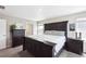 Bedroom with a dark wood bed, neutral walls, carpet flooring, and two large dressers at 27130 E Maple Ave, Aurora, CO 80018