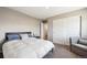 Cozy bedroom with carpeted floors, modern gray chair, and ample closet space at 27130 E Maple Ave, Aurora, CO 80018