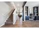 Inviting entryway featuring hardwood floors, staircase, adjacent office space, and a glimpse of the living room at 27130 E Maple Ave, Aurora, CO 80018