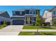 Beautiful two-story home featuring a yellow front door, attached garage, and well-maintained front yard at 27130 E Maple Ave, Aurora, CO 80018