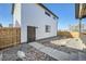View of backyard featuring a dark wood privacy fence, a modern black door, and low maintenance gravel landscaping at 307 W Charles St, Superior, CO 80027