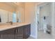 Bright bathroom featuring a modern vanity, ample mirror space, and a separate toilet area at 307 W Charles St, Superior, CO 80027