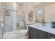 Stylish bathroom showcasing a glass-enclosed shower, gray vanity with a white countertop, and modern fixtures at 307 W Charles St, Superior, CO 80027