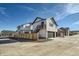 Home with neutral siding and dark trim features a two-car garage, stairway, and well-maintained landscaping at 307 W Charles St, Superior, CO 80027