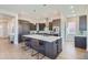 Gourmet kitchen featuring an oversized island with seating, a wine rack, and stainless steel appliances at 307 W Charles St, Superior, CO 80027