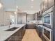 Gourmet kitchen boasting stainless steel appliances, modern backsplash, and an oversized island with a sink at 307 W Charles St, Superior, CO 80027