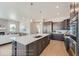 Open concept kitchen showcasing an oversized island with seating, stainless steel appliances, and eat in dining area at 307 W Charles St, Superior, CO 80027