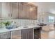 Charming wet bar featuring stone countertops, a wine cooler, and stylish gray cabinetry at 307 W Charles St, Superior, CO 80027