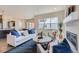 Bright living room with large windows, a fireplace, stylish furniture, and an open floor plan at 307 W Charles St, Superior, CO 80027