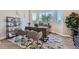 Well-lit office space with a wooden desk, comfortable chairs, and ample natural light from large windows at 307 W Charles St, Superior, CO 80027