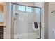 Glass enclosed tiled shower with white subway tile and a window for natural light at 307 W Charles St, Superior, CO 80027
