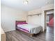 Bedroom with hardwood floors, natural light, closet, and is tastefully decorated in neutral tones at 2644 S Norfolk St, Aurora, CO 80013