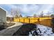 Fenced backyard featuring a winding pathway, newly laid mulch, and a vibrant, sunny atmosphere at 7882 S Independence Way, Littleton, CO 80128
