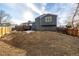 Expansive backyard with a wooden deck, privacy fence, and ample space for outdoor activities at 7882 S Independence Way, Littleton, CO 80128