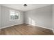 Bright bedroom features wood-look floors and a window for natural light at 7882 S Independence Way, Littleton, CO 80128