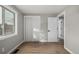 Empty bedroom with wood flooring, closet and window providing natural light at 7882 S Independence Way, Littleton, CO 80128