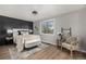 Cozy bedroom with stylish furniture, wood flooring, and a large window for natural light at 7882 S Independence Way, Littleton, CO 80128