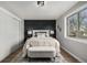 Bedroom featuring neutral tones, with a comfortable bed and a black accent wall at 7882 S Independence Way, Littleton, CO 80128