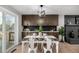 Stylish dining room with a modern light fixture, built-in cabinets, and access to backyard at 7882 S Independence Way, Littleton, CO 80128