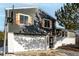 A close up of the home featuring white garage door, gray siding, and wooden shutters at 7882 S Independence Way, Littleton, CO 80128