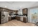 Well-equipped kitchen featuring stainless steel appliances, marble countertops, and wood cabinets at 7882 S Independence Way, Littleton, CO 80128