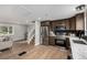 Modern kitchen featuring stainless steel appliances, dark cabinetry, and a spacious layout with wood flooring at 7882 S Independence Way, Littleton, CO 80128