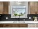 Bright kitchen sink with quartz countertops, stainless steel sink, and a view of the outside at 7882 S Independence Way, Littleton, CO 80128