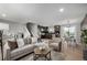 Spacious living room with a staircase, hardwood floors, open kitchen, and dining area at 7882 S Independence Way, Littleton, CO 80128