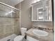 Clean bathroom with shower, toilet and updated vanity at 12644 W Virginia Ave, Lakewood, CO 80228