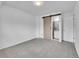 Spacious bedroom with grey carpet, barn door, and access to bathroom at 12644 W Virginia Ave, Lakewood, CO 80228