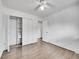 Bedroom with wood-look flooring, double door closet and ceiling fan at 12644 W Virginia Ave, Lakewood, CO 80228