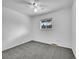 Simple bedroom with grey carpet, ceiling fan and window at 12644 W Virginia Ave, Lakewood, CO 80228