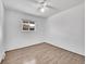 Bedroom featuring wood-look flooring, a ceiling fan and a window at 12644 W Virginia Ave, Lakewood, CO 80228