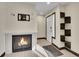 Bright entryway with fireplace, built-in shelving, and hardwood floors at 12644 W Virginia Ave, Lakewood, CO 80228