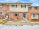 Brick front exterior of a charming two-story home with a blue door at 12644 W Virginia Ave, Lakewood, CO 80228