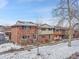 Brick front of townhome with snow-covered yard at 12644 W Virginia Ave, Lakewood, CO 80228