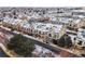 Aerial view of townhomes with balconies, garages, snow-covered roofs, and a view of the open spaces and community at 1861 Mallard Dr, Superior, CO 80027