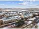 Townhome community aerial view showcases balconies, attached garages and snow covered roofs with a view of the open spaces at 1861 Mallard Dr, Superior, CO 80027