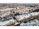 Aerial view of townhomes with green roofs in a snowy landscape, highlighting their inviting curb appeal and convenient parking at 1861 Mallard Dr, Superior, CO 80027