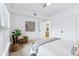 Comfortable bedroom featuring a decorative mirror and a cozy armchair and doorway at 1861 Mallard Dr, Superior, CO 80027